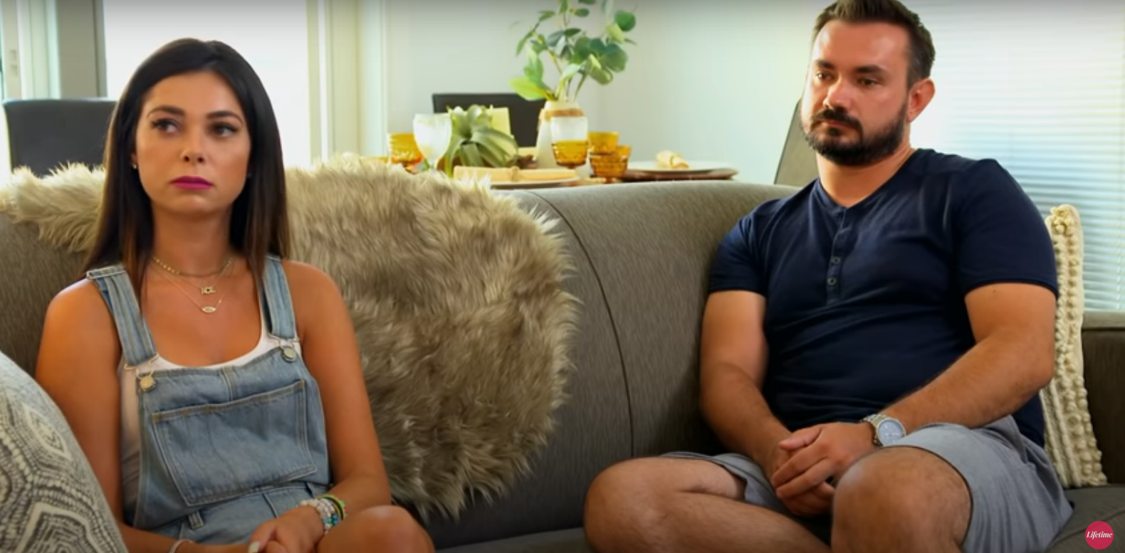 Alyssa and Chris sitting on a couch in 'Married at First Sight'