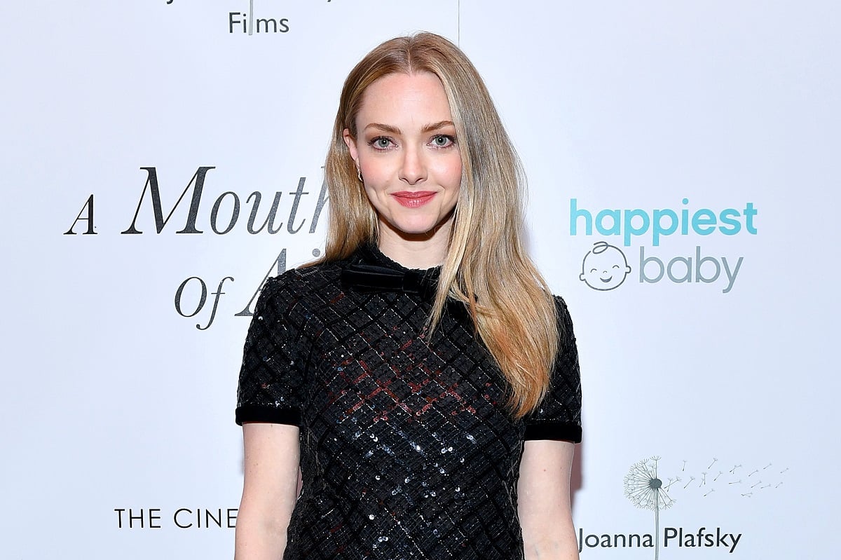 Amanda Seyfried smiling while wearing a black dress.