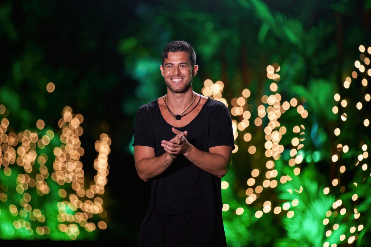 Andre Brunelli smiling in front of trees during an episode of 'Love Island'