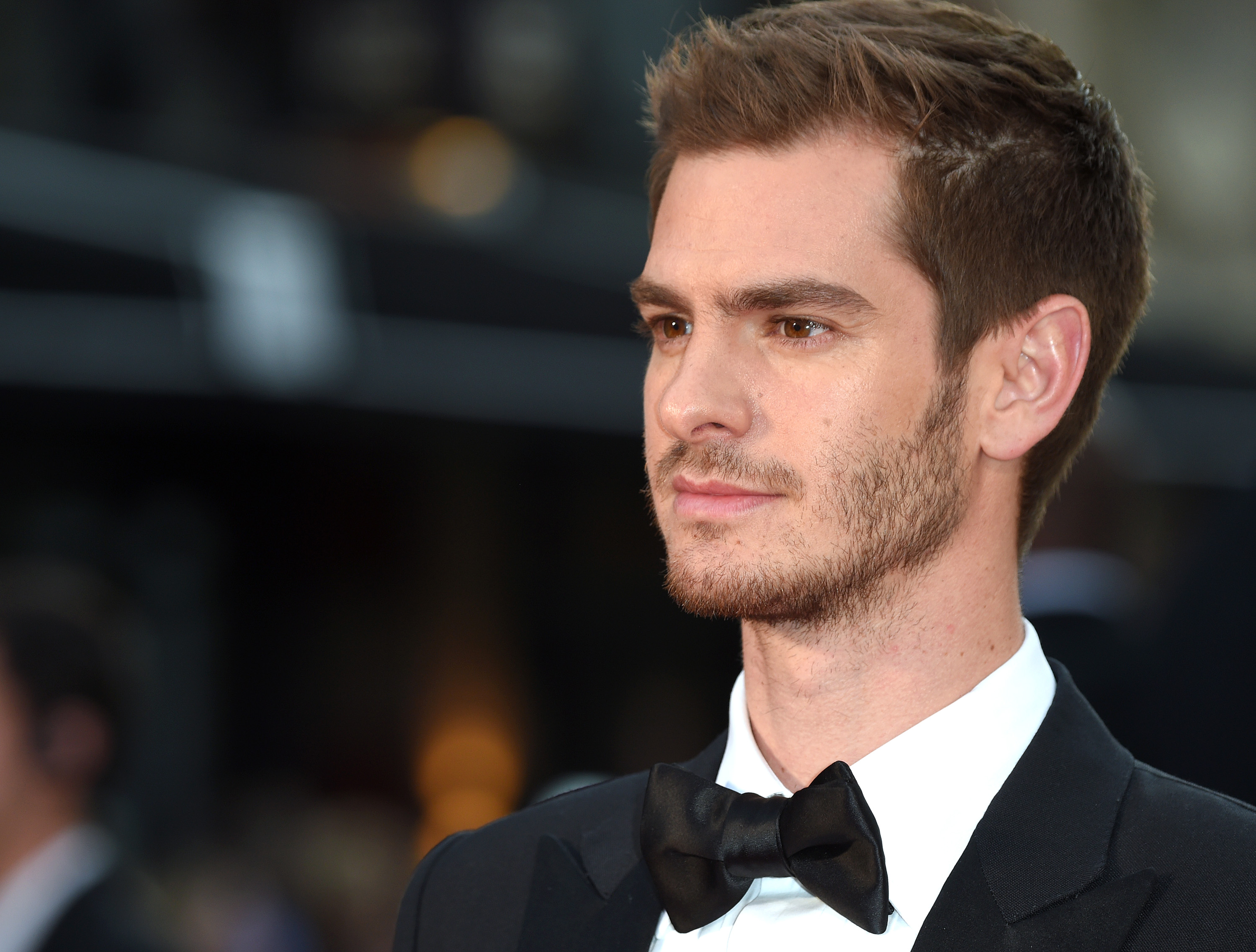 'Spider-Man: No Way Home' star Andrew Garfield wears a black suit over a white button-up shirt and black bow tie.