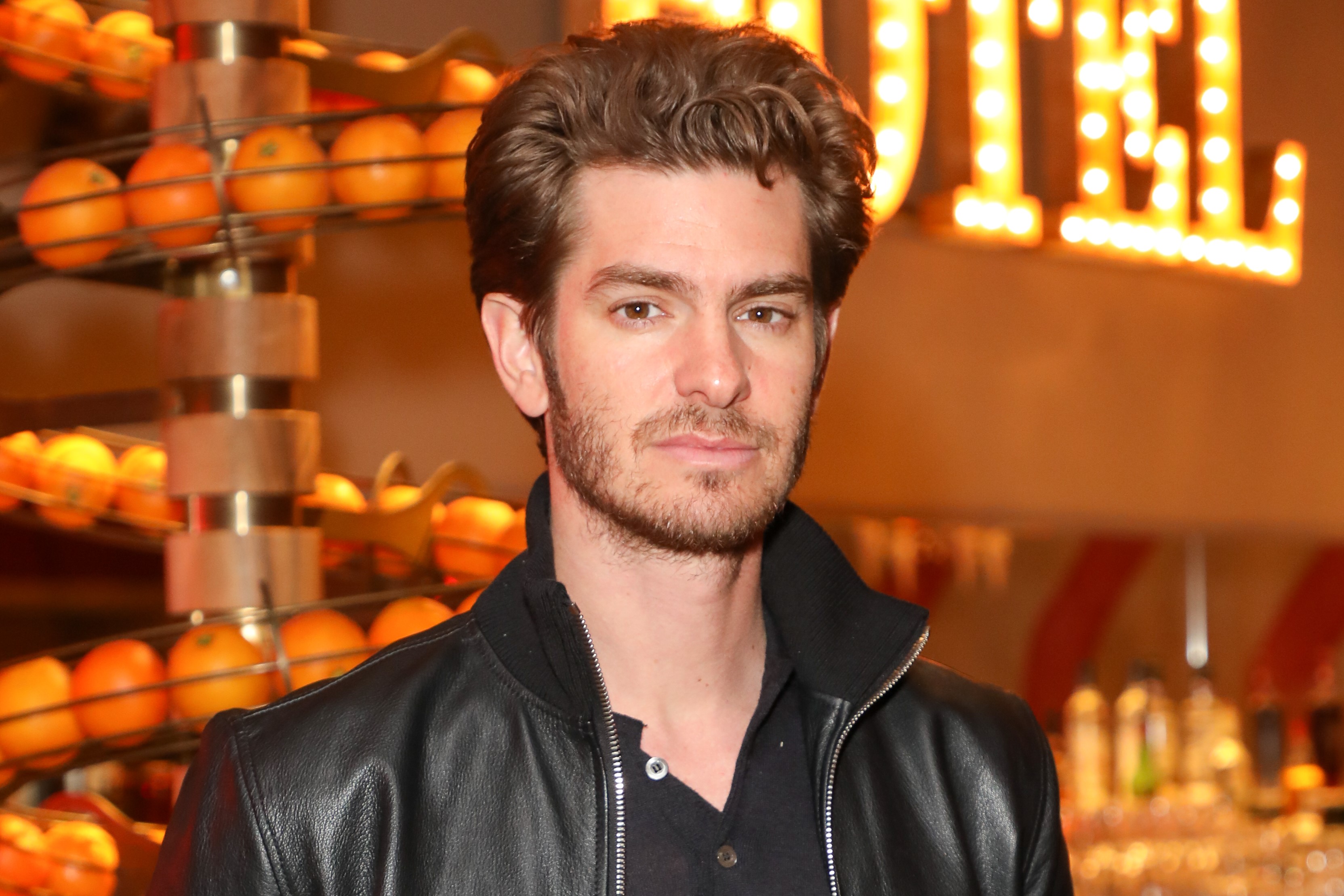 'Spider-Man: No Way Home' star Andrew Garfield wears a black leather jacket over a black shirt.