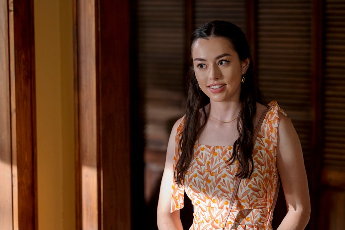 Anneliese Judge as Annie, wearing a orange-patterned sleeveless dress, in 'Sweet Magnolias' Season 2
