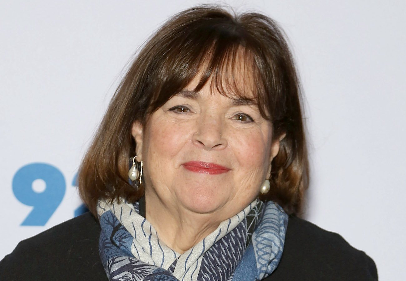 Ina Garten smirks wearing a blue scarf