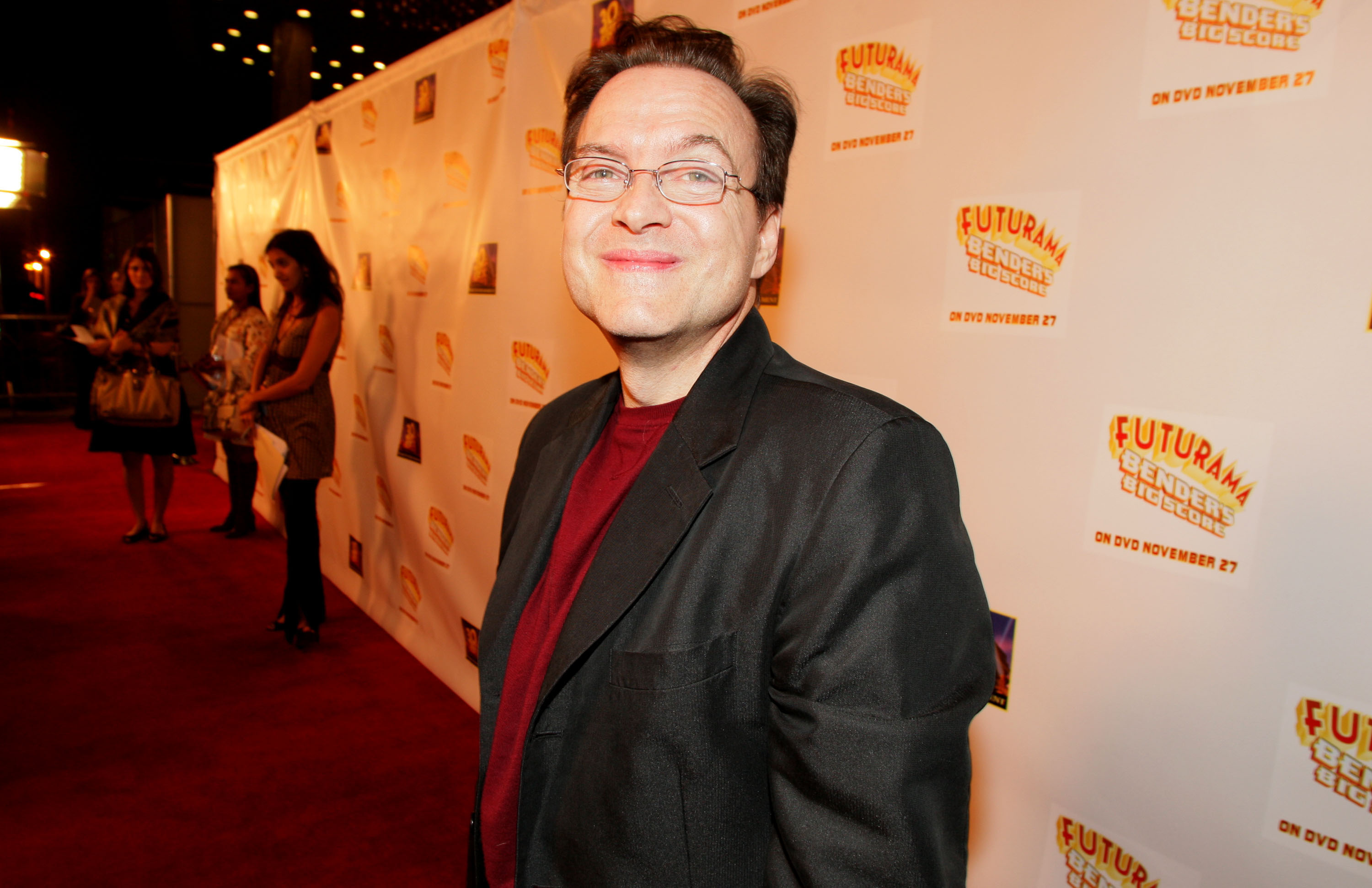 'Futurama' actor Billy West wearing a black jacket, red shirt, and glasses.
