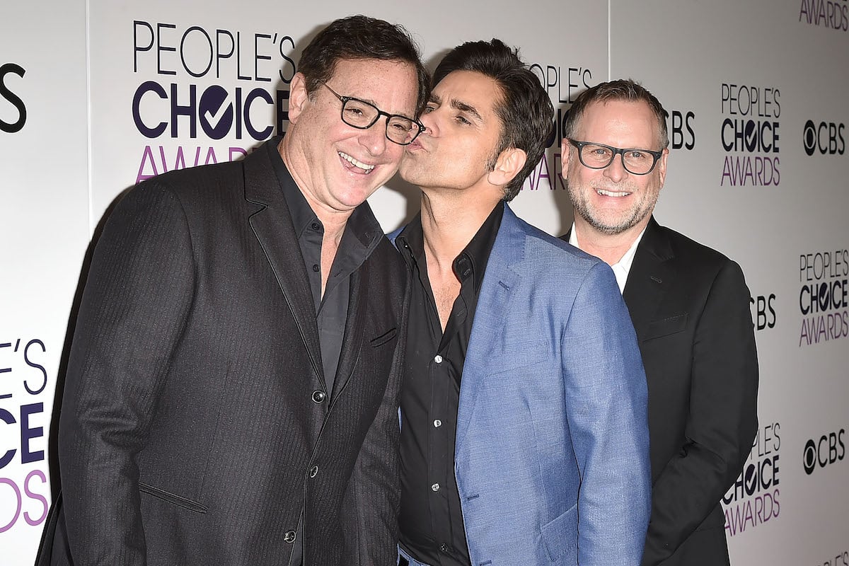 John Stamos kisses Bob Saget's cheek at an event.