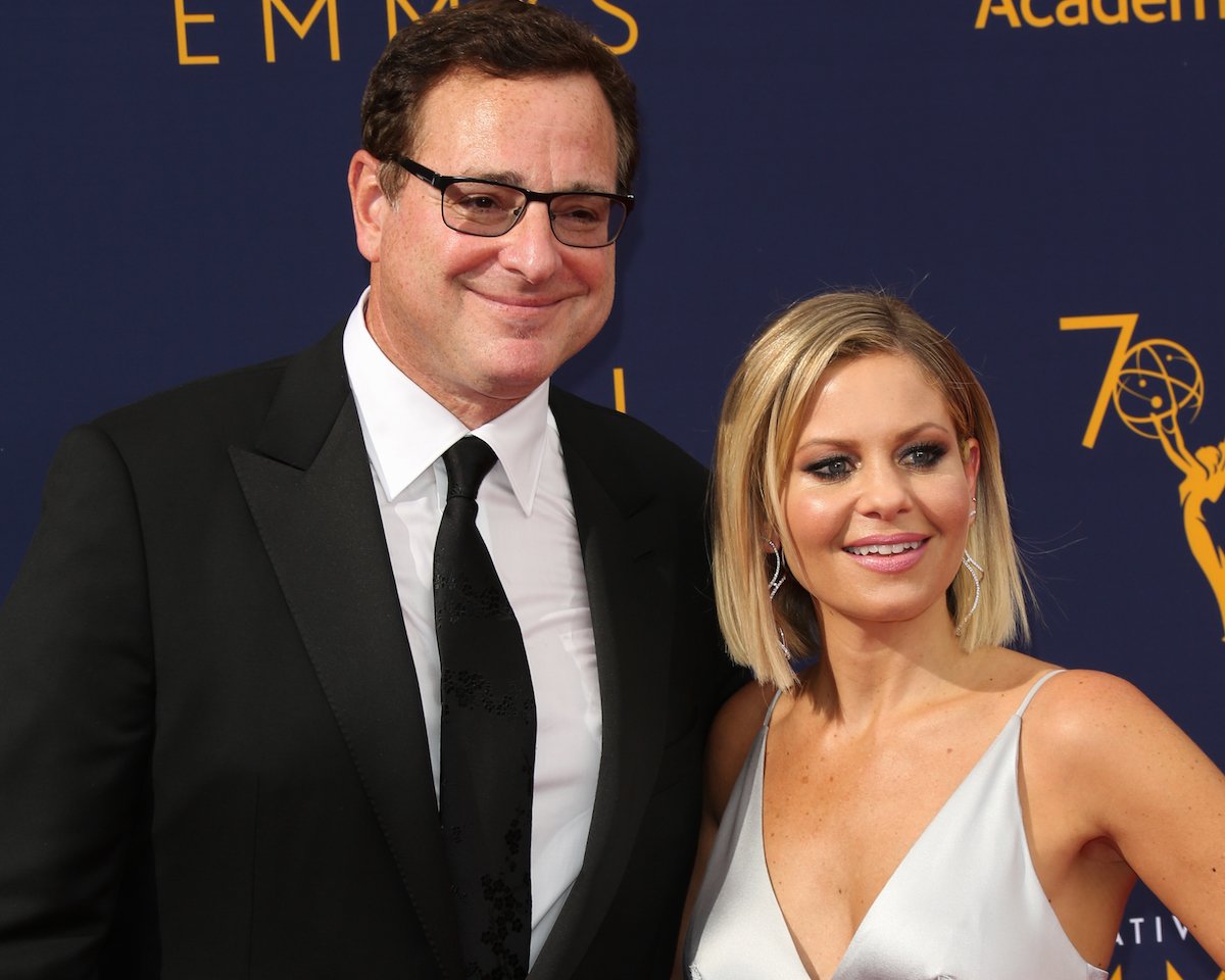 Bob Saget and Candace Cameron Bure pose together at an event.