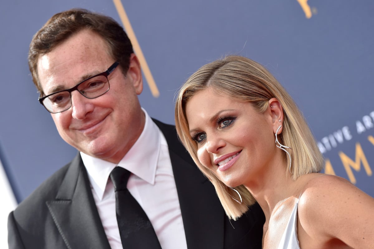 Bob Saget and Candace Cameron Bure pose together at an event.