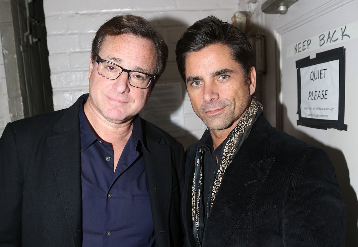 Bob Saget and John Stamos pose together.