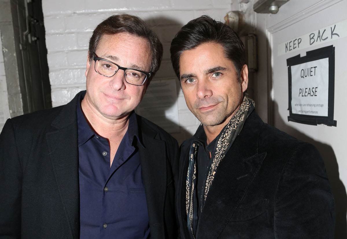 Bob Saget and John Stamos pose together.