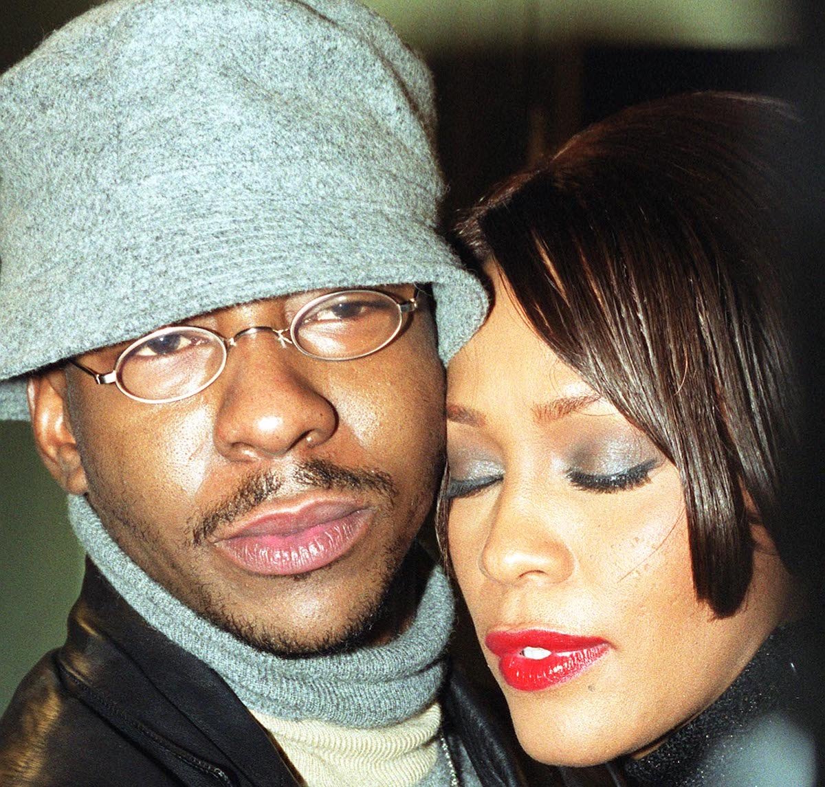Bobby Brown and Whitney Houston embrace one another