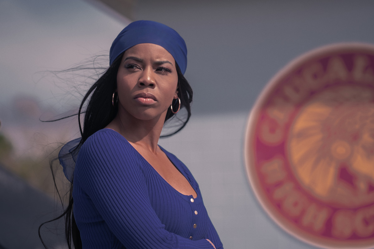 Brandee Evans as Mercedes on 'P-Valley' wearing a blue shirt and blue head wrap.