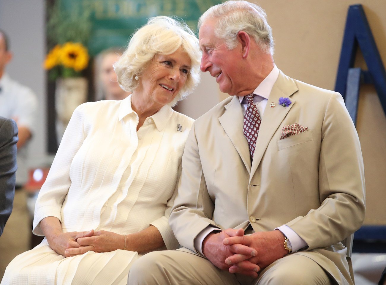 Camilla Parker Bowles and Prince Charles leaning into each other and smiling