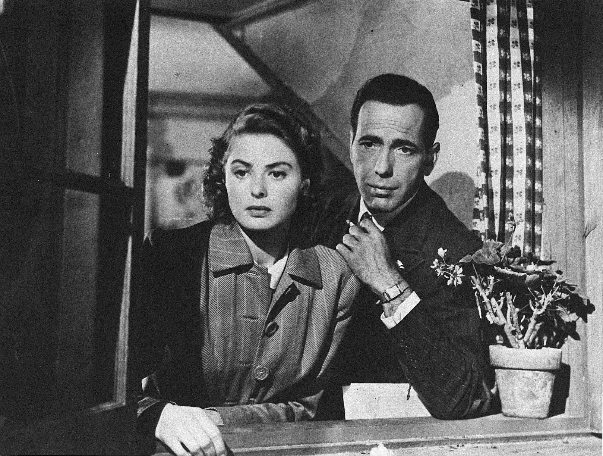 'Casablanca' Ingrid Bergman as Ilsa Lund and Humphrey Bogart as Rick Blain looking out the window next to a potted plant