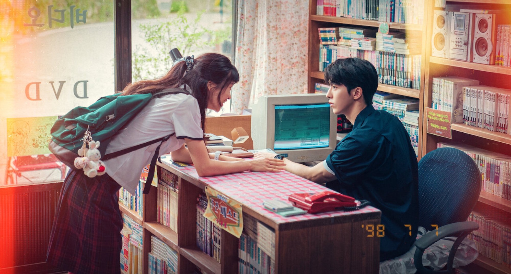 Characters Hee-do and Yi-jin in 'Twenty-Five Twenty-One' age-gap relationship in comic book shop.