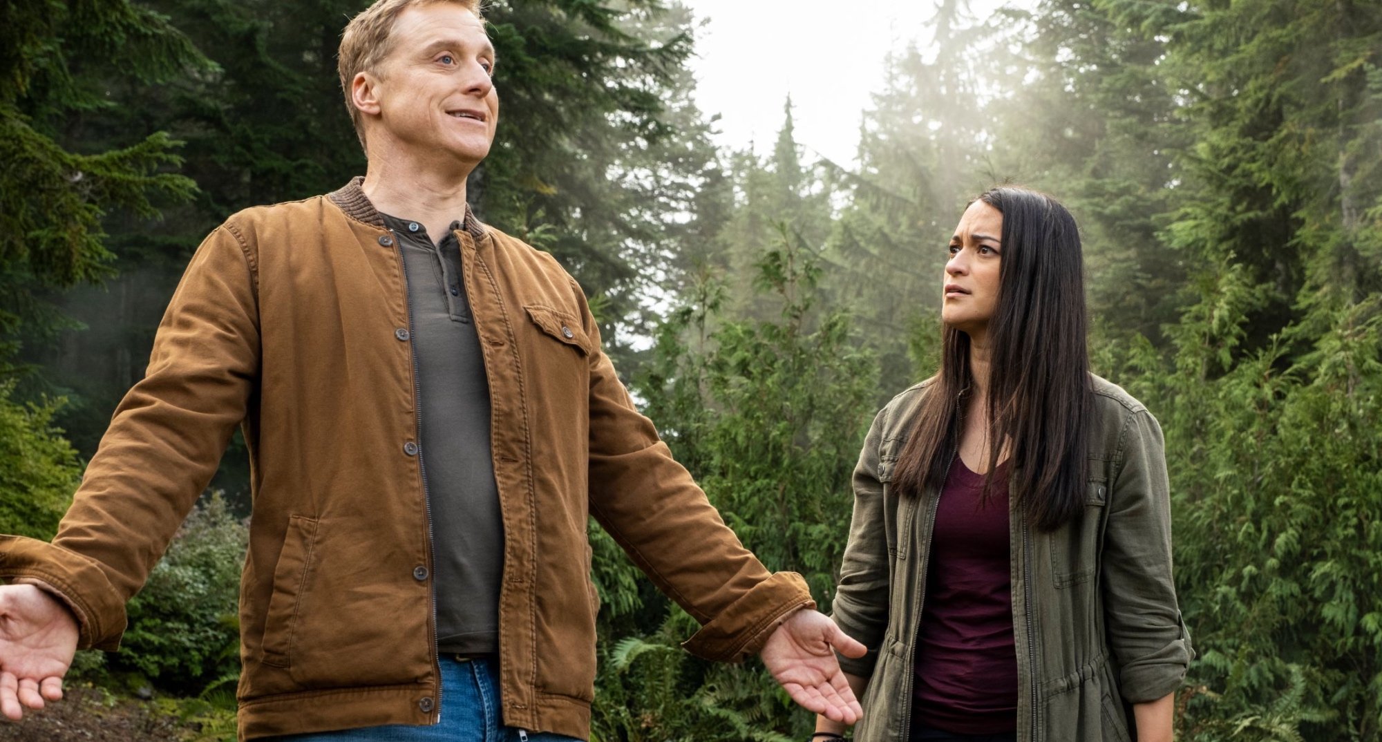 Characters Henry and Asta for 'Resident Alien' filming locations in a forest.