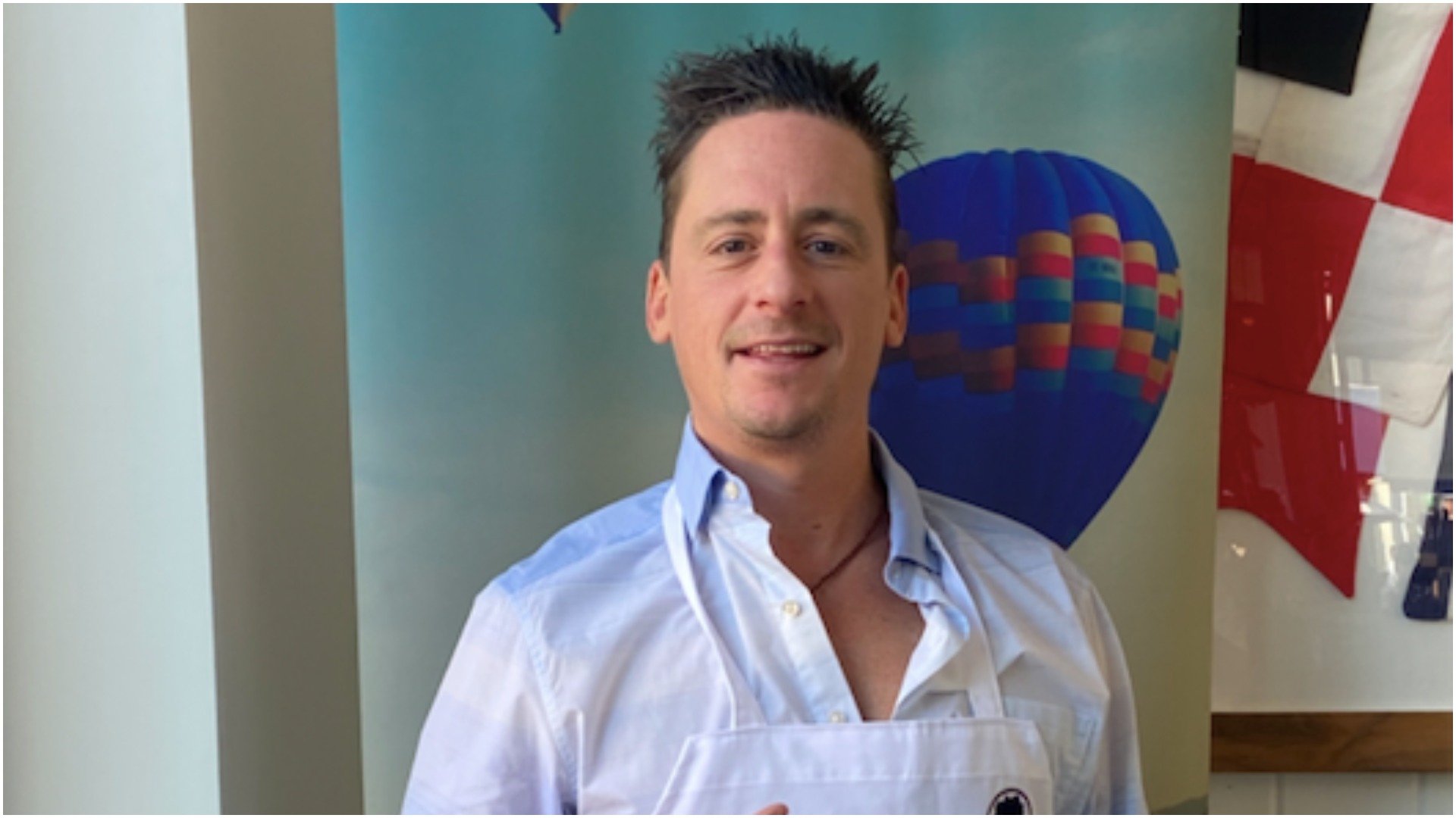 Chef Ben Robinson poses for a photo wearing one of his aprons 