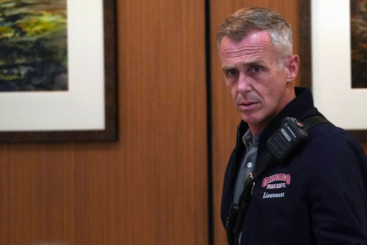 David Eigenberg as Christopher Herrmann in Chicago Fire Season 10. Herrmann wears a jacket that reads, 'Chicago Fire Department Lieutenant.'