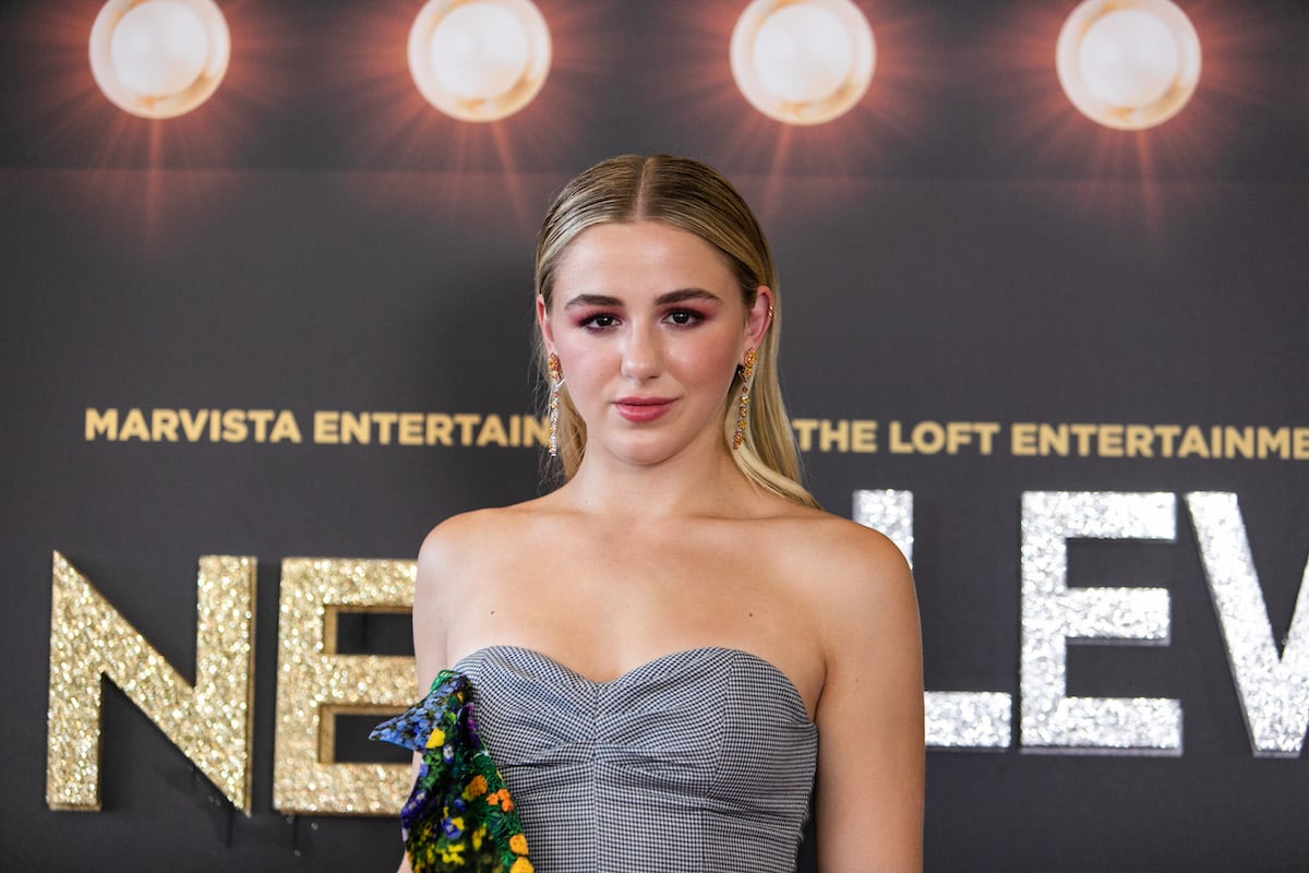 Chloé Lukasiak wears a grey dress 