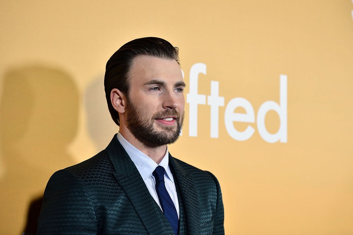 Chris Evans smiling while wearing a suit.