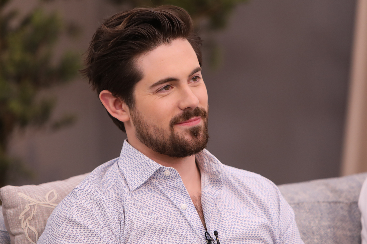 Chris McNally sitting on a couch during an appearance on 'Home & Family'