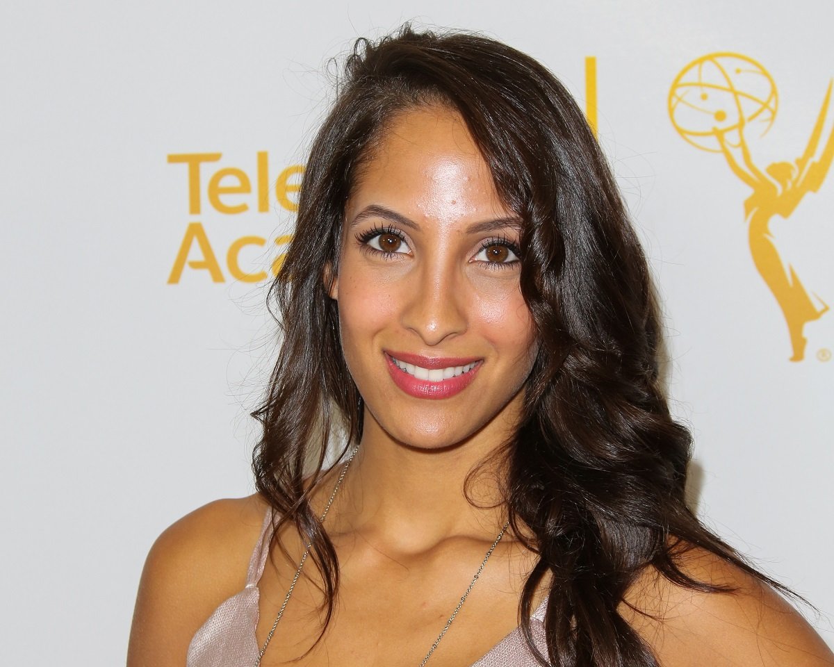 'The Young and the Restless' actor Christel Khalil wearing a pink jumpsuit during a red carpet appearance.