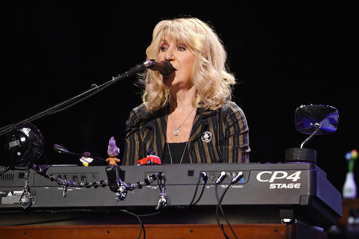 Christine McVie sings while playing the keyboard.