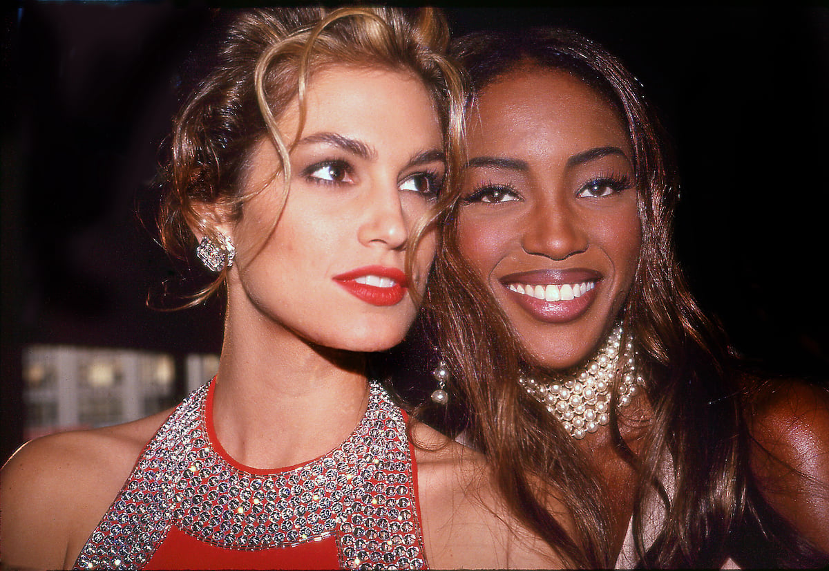 Models Cindy Crawford and Naomi Campbell smiles together at a private party in 1992