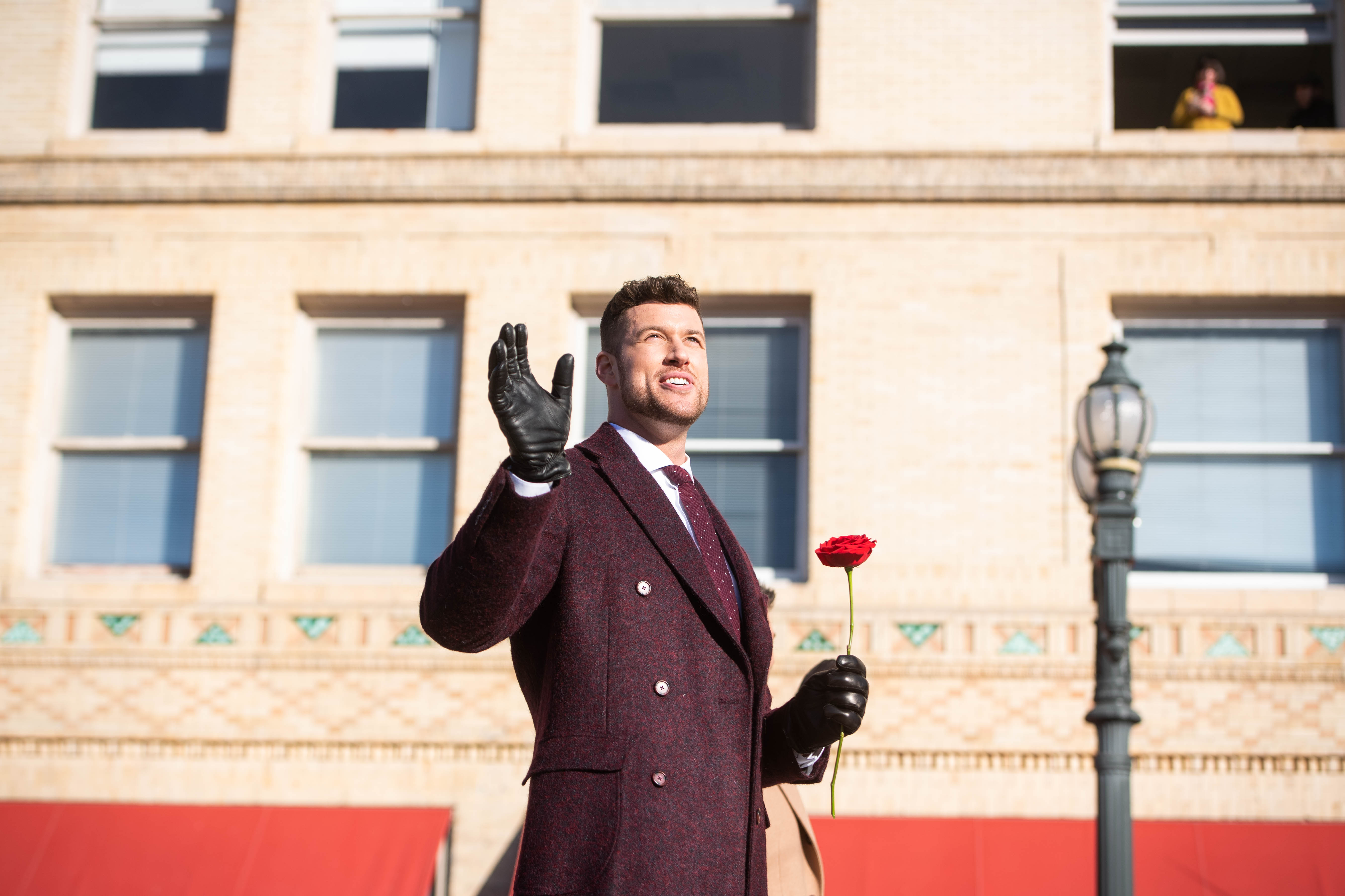 'The Bachelor' star Clayton Echard waves holding a rose