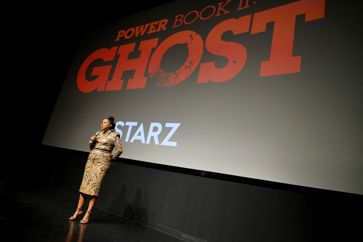 Courtney Kemp wears a printed dress onstage at an event for 'Power Book II: Ghost'