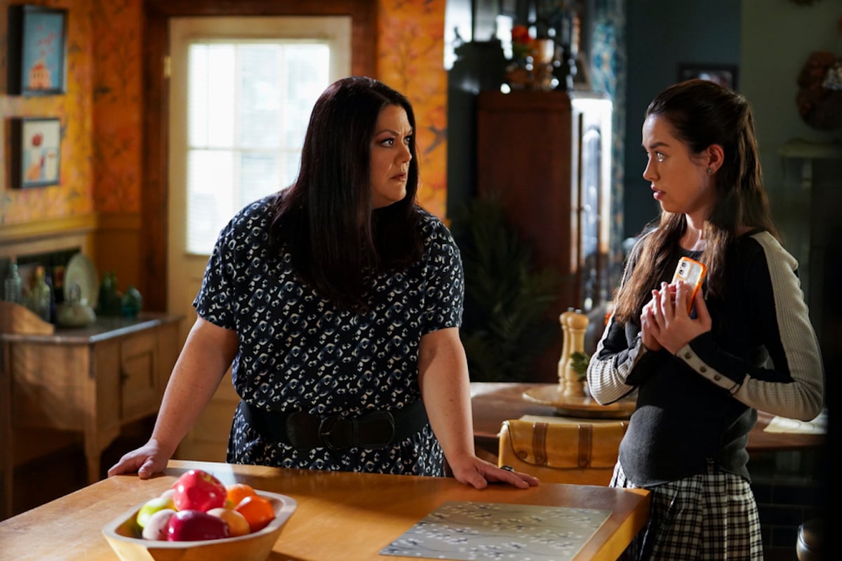 Dana Sue with her hands on a counter, talking to her daughter Annie in 'Sweet Magnolias' Season 2 
