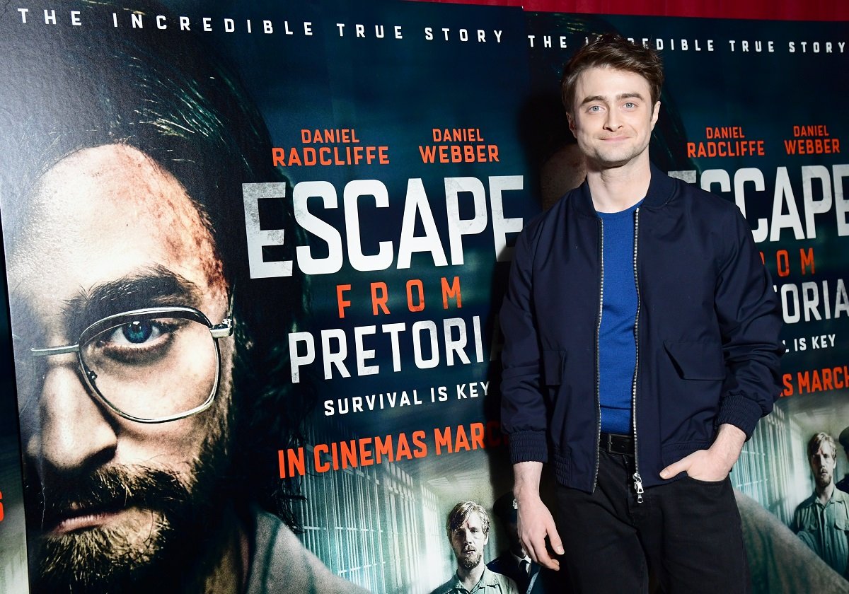 Daniel Radcliffe smiling while wearing a jacket.