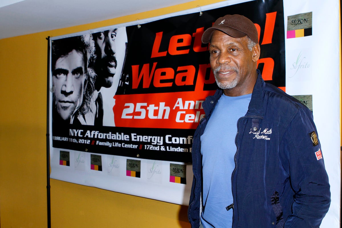 Danny Glover stands in front of a ‘Lethal Weapon’ poster