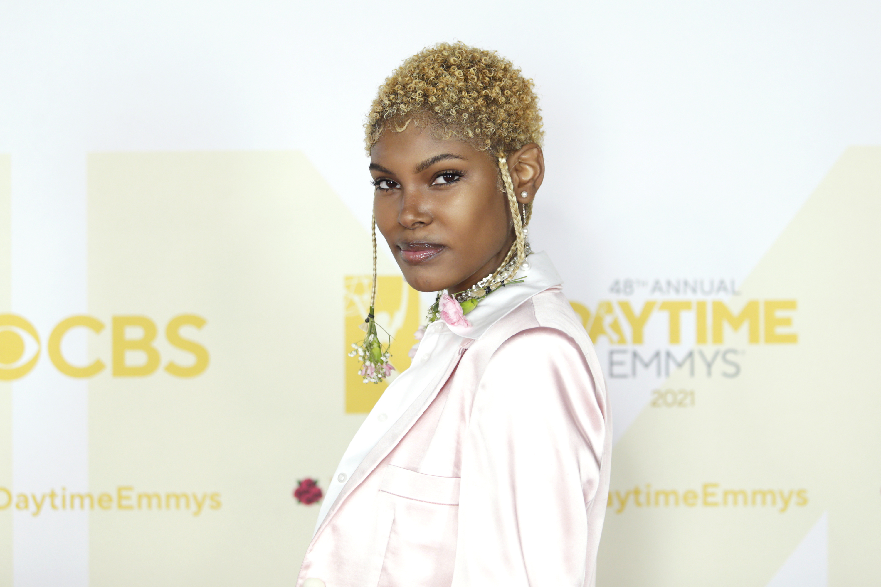 'The Bold and the Beautiful' actor Diamond White wearing a light pink jacket during a red carpet appearance.