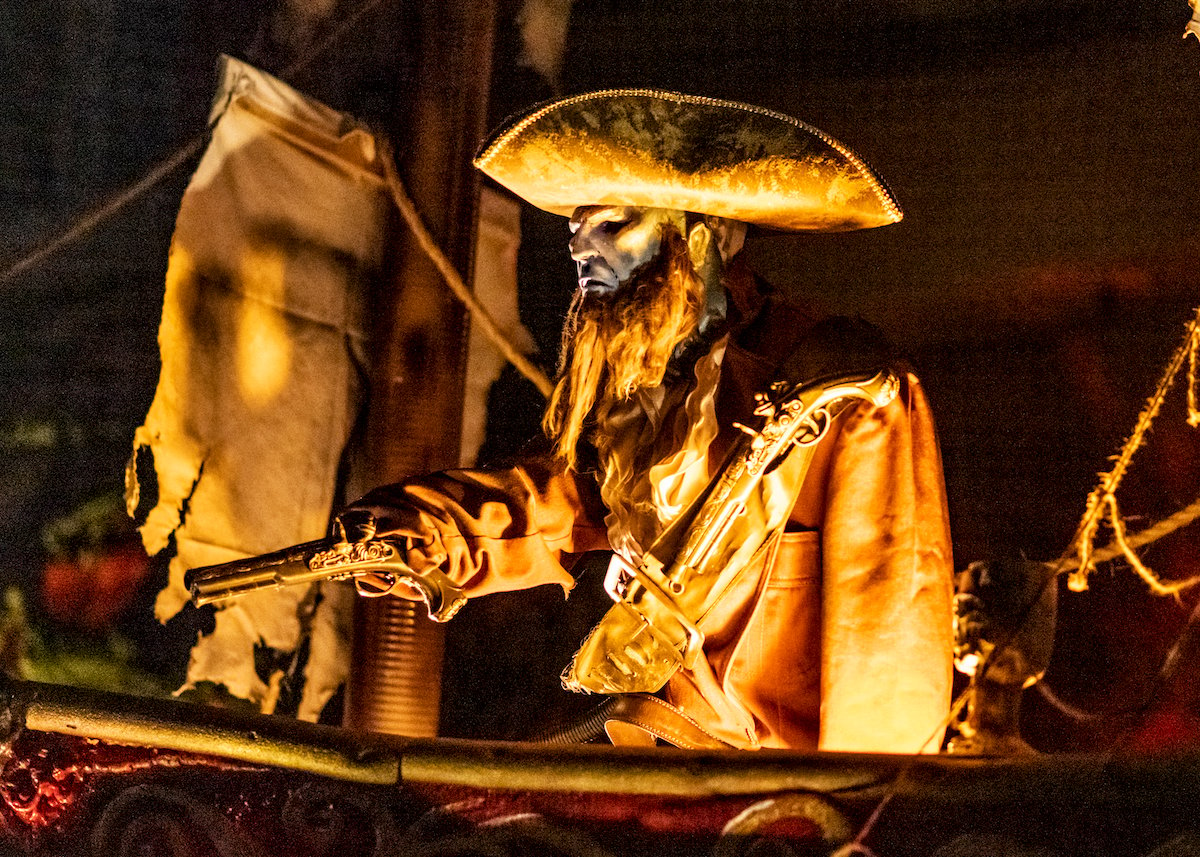 A skeleton pirate rests on the deck of a replica pirate ship from Disneyland's Pirates of the Caribbean ride