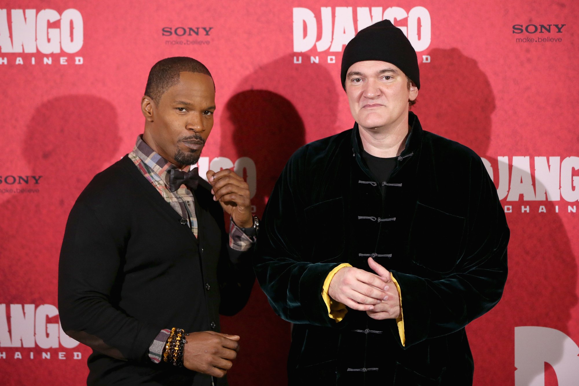 'Django Unchained' Jamie Foxx and Quentin Tarantino standing in front of red movie step and repeat