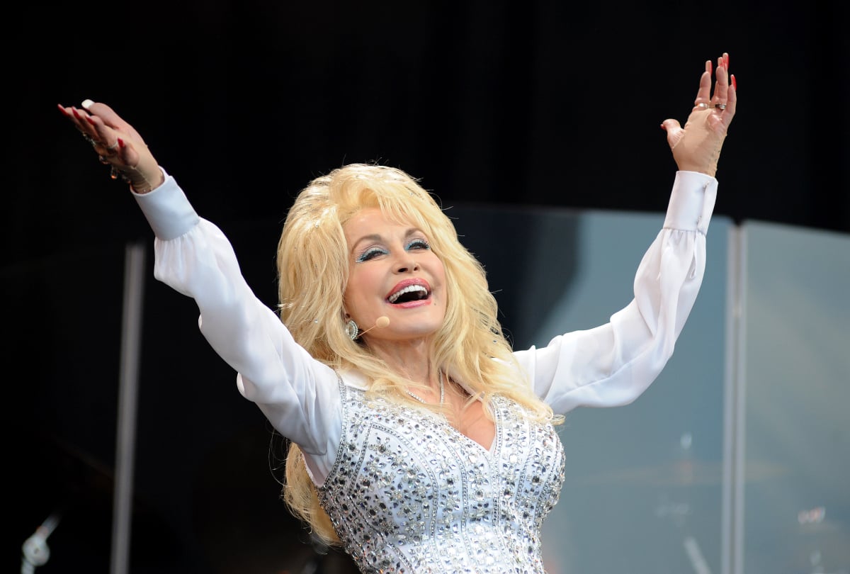 Taco Bell lover Dolly Parton with her arms raised to the sky performs on the Pyramid stage on Day 3 of the Glastonbury Festival at Worthy Farm on June 29, 2014 in Glastonbury, England