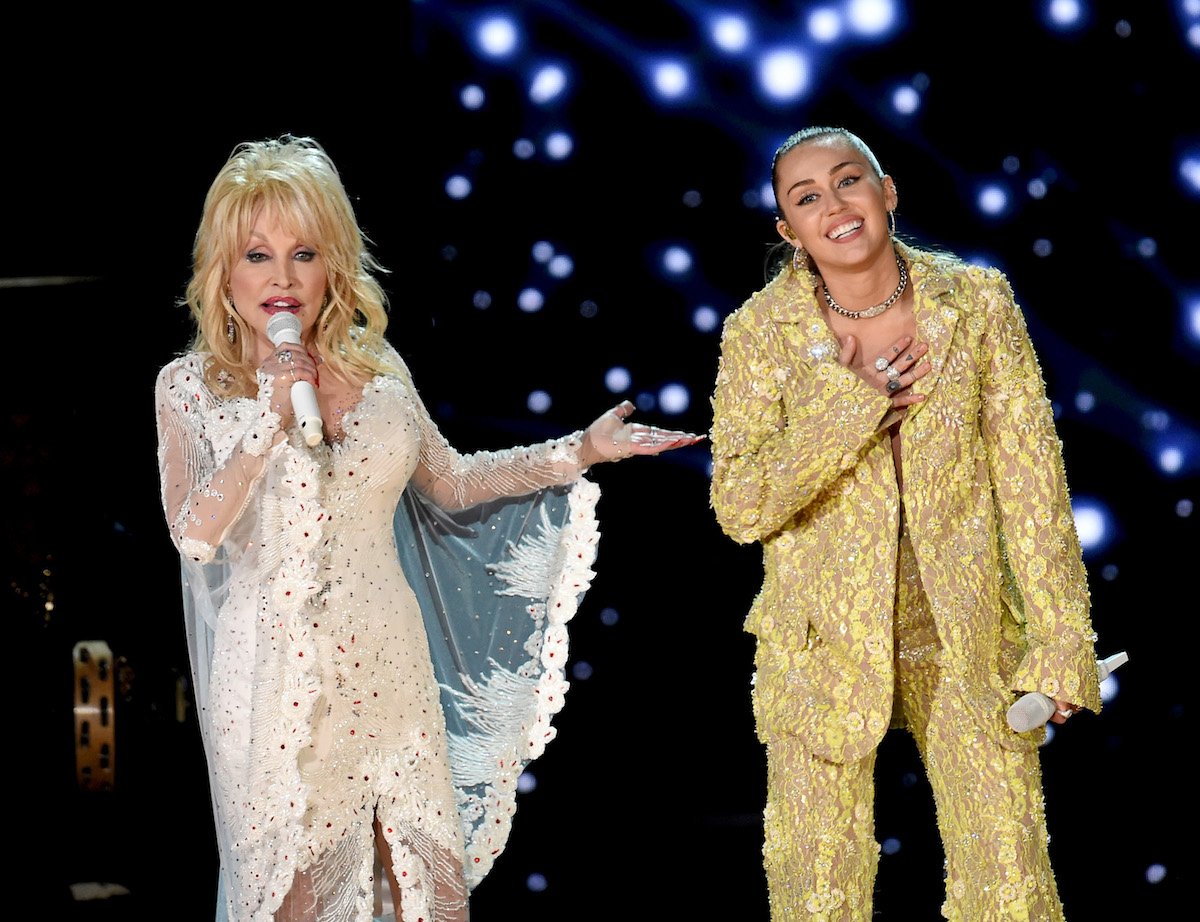 Dolly Parton and Miley Cyrus perform together on stage.