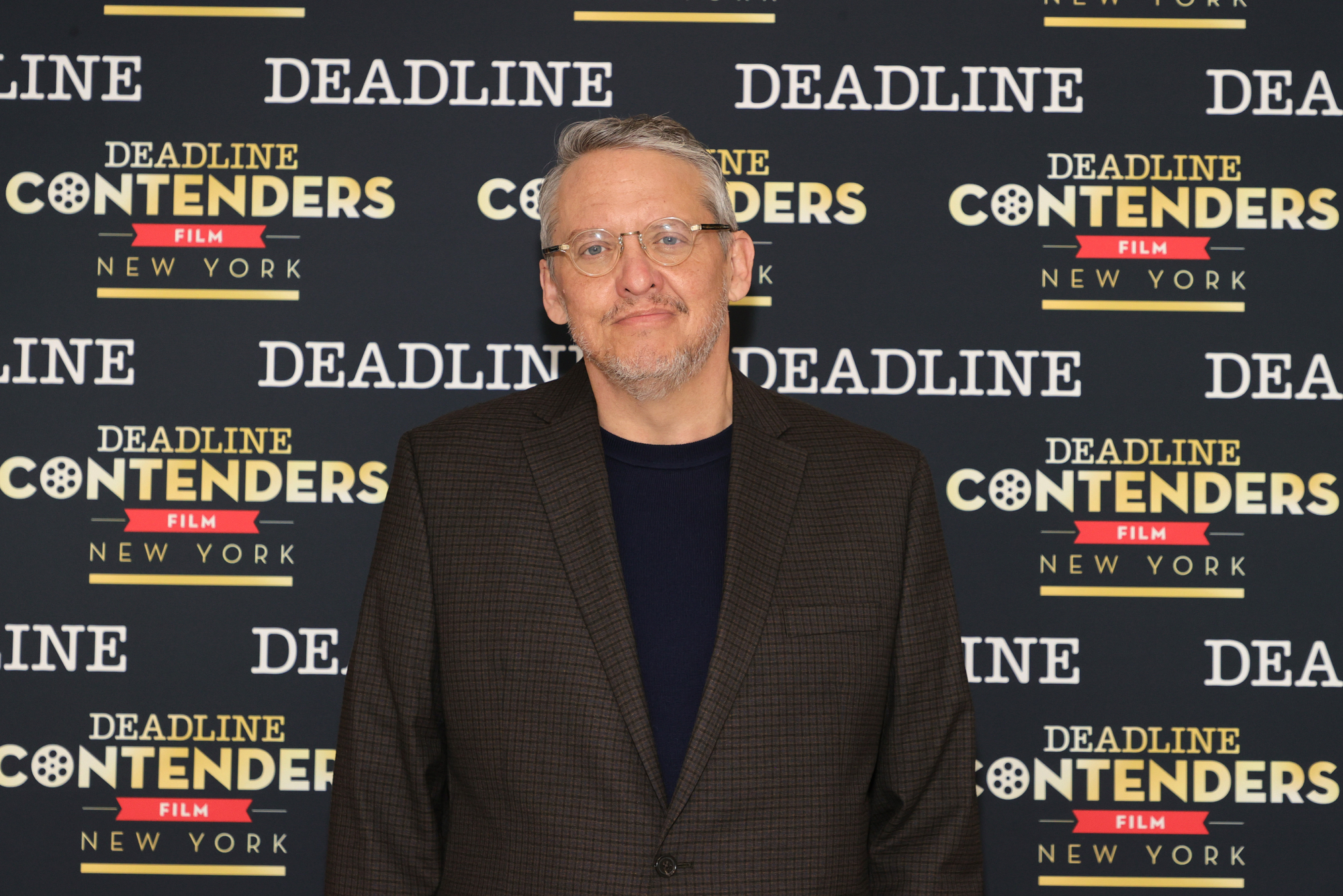 'Don't Look Up' filmmaker Adam Mckay standing in front of a Deadline step and repeat