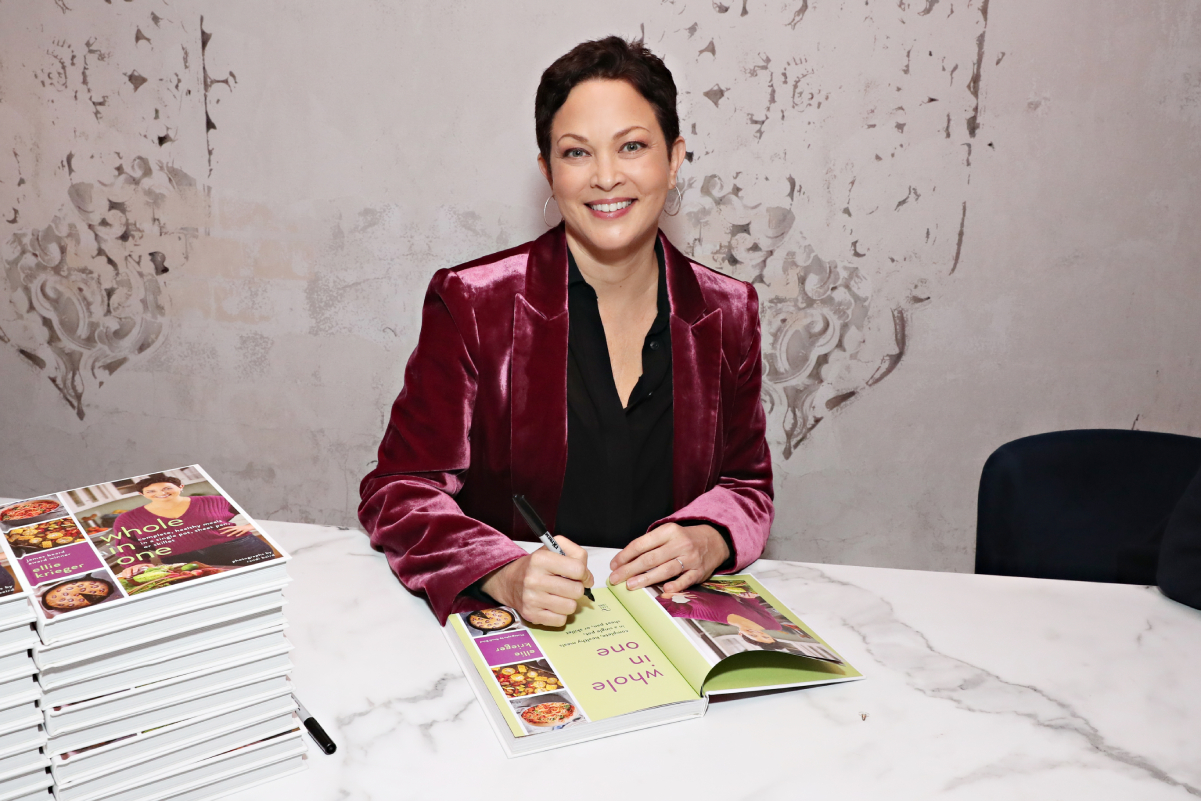 Food Network host Ellie Krieger wears a purple jacket at a 2019 book signing event.