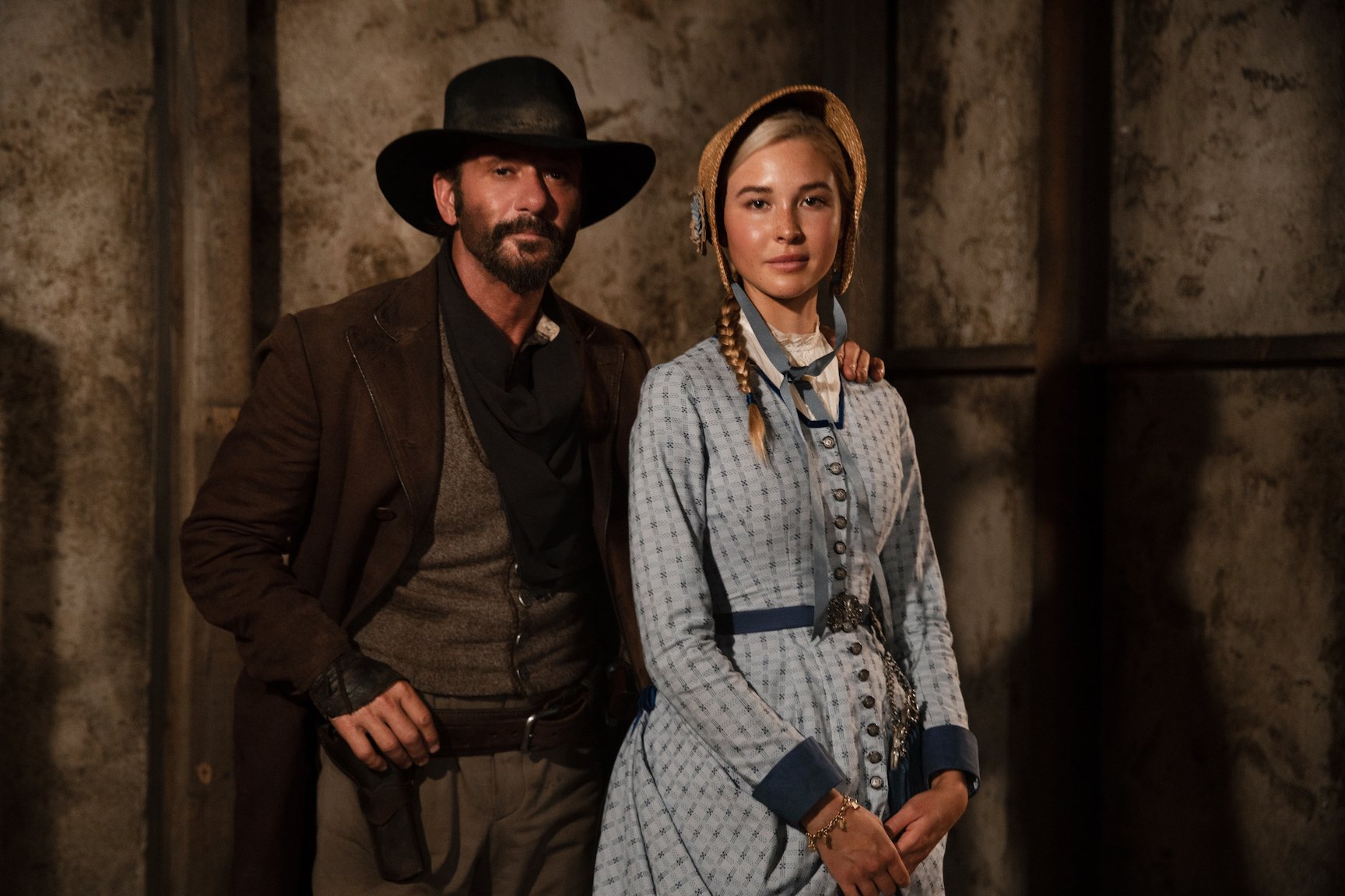 '1883' stars Tim McGraw as James Dutton and Isabel May as Elsa Dutton standing together for a portrait