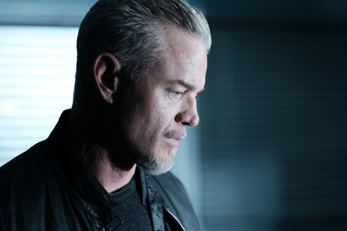 Eric Dane as Cal Jacobs in Euphoria Season 2. Cal wears a black sweater and black leather jacket and looks serious.