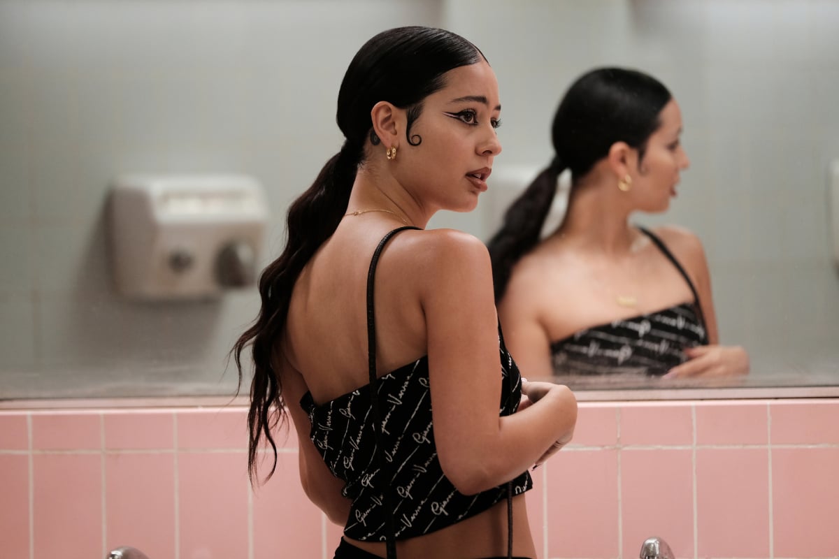 Alexa Demie as Maddy in Euphoria Season 2. Maddy wears a black crop top and her hair in a low ponytail. 