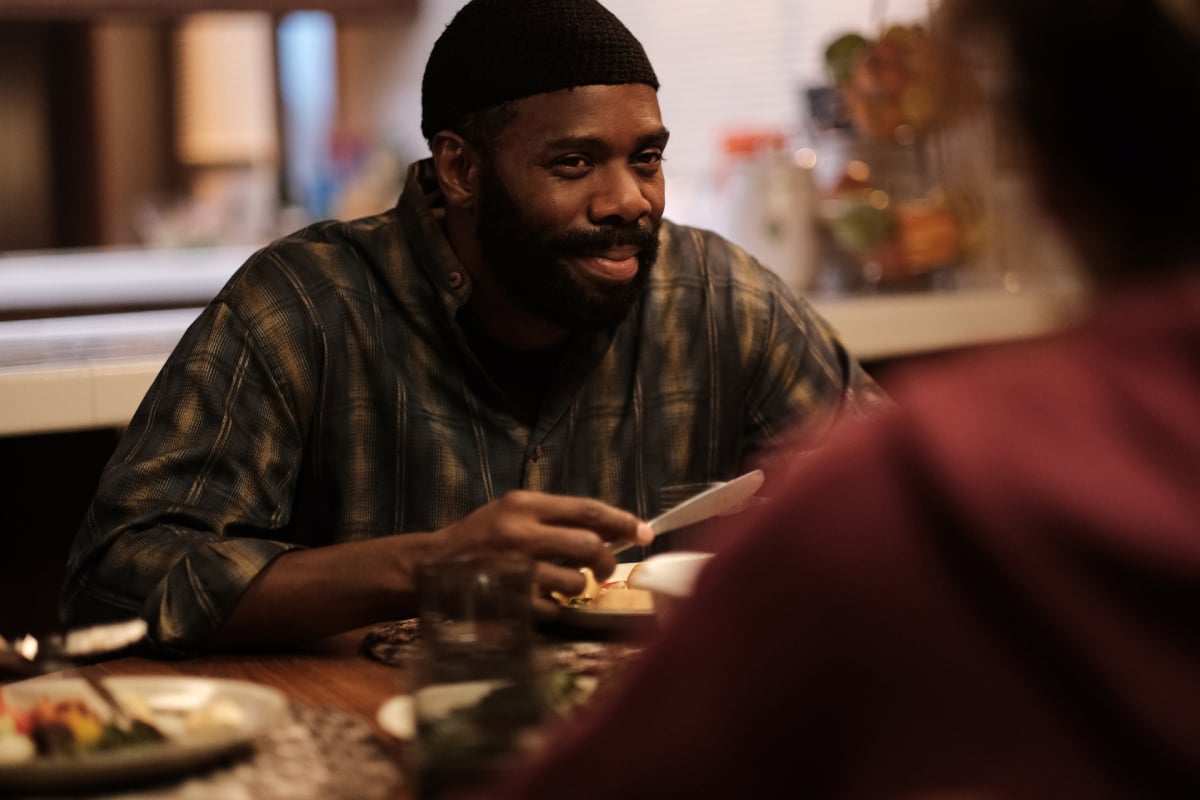 Colman Domingo as Ali in Euphoria Season 2. Ali sits across from Rue at the dinner table and smiles.