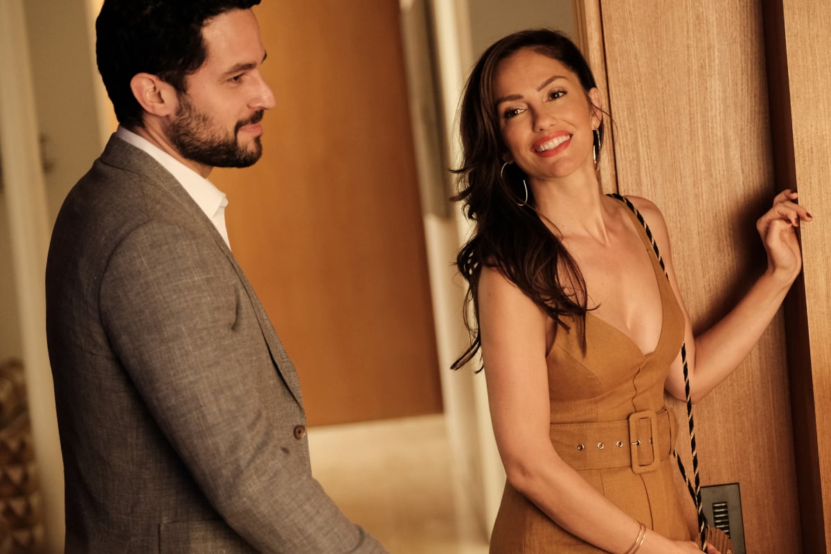 Fernando Belo as Sebastian and Minka Kelly as Samantha in Euphoria Season 2. Samantha wears and tan-colored dress and Sebastian wears a suit.