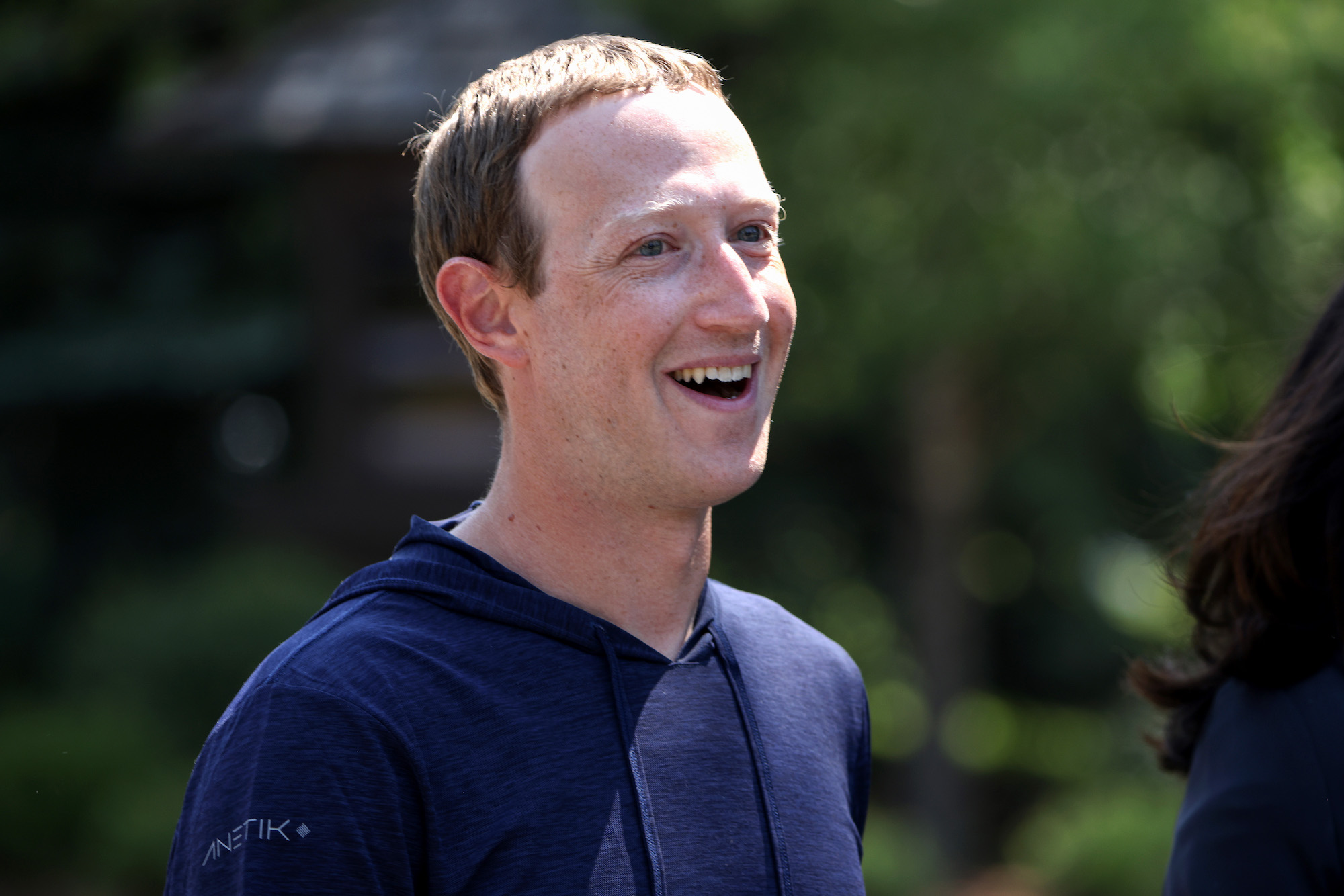 Faceobok CEO Mark Zuckerberg smiles during a walk outside