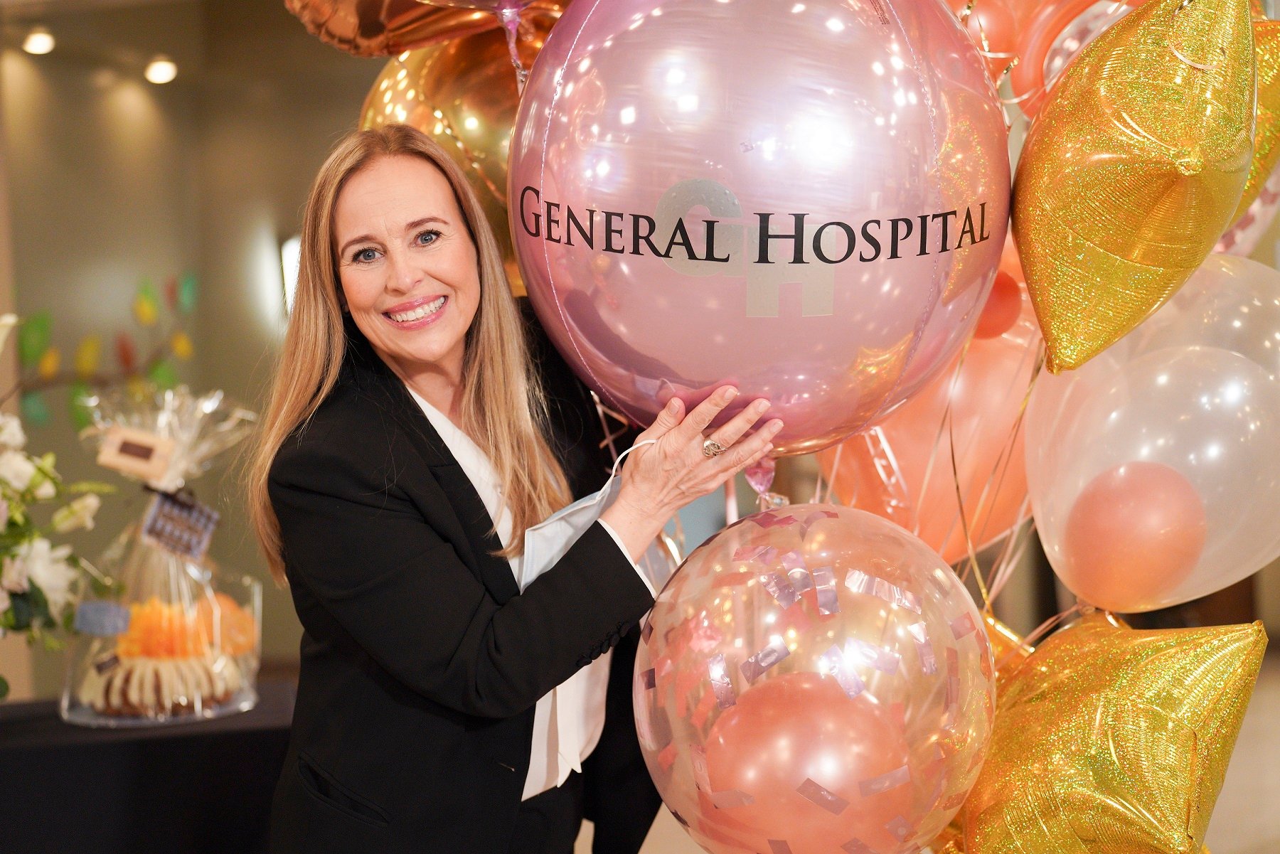 General Hospital star Genie Francis holding a balloon and wearing a black blazer