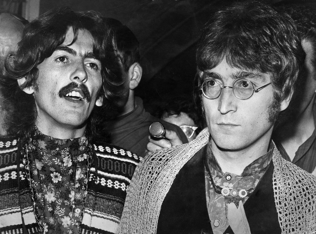 George Harrison and John Lennon talking at a press conference in Bangor following the death of their manager, Brian Epstein, 1967.