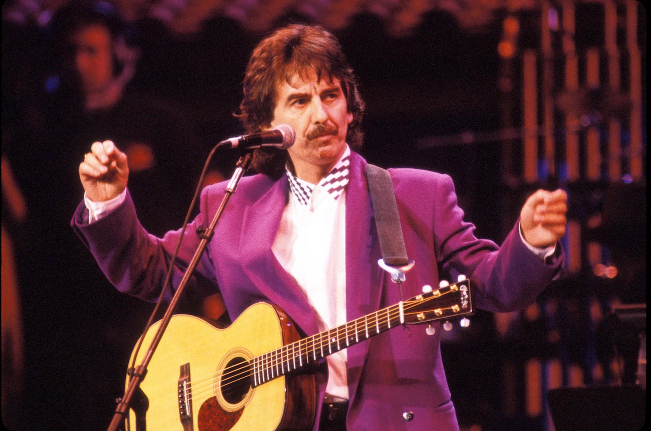George Harrison performing in a purple suit at Bob Dylan's 30th Anniversary Concert in New York, 1992.