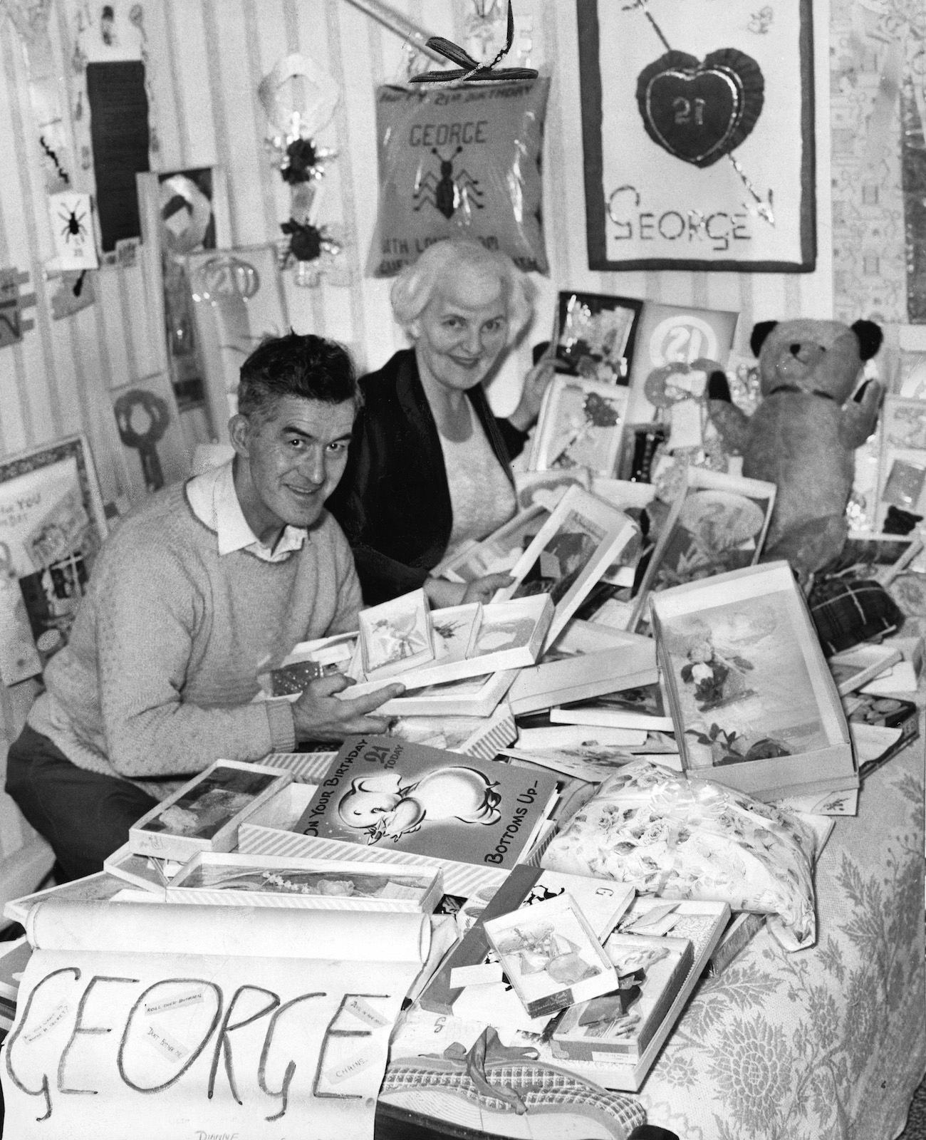 George Harrison's parents, Harold and Louise, looking through the birthday cards they were sent by their son's fans on his 21st birthday.