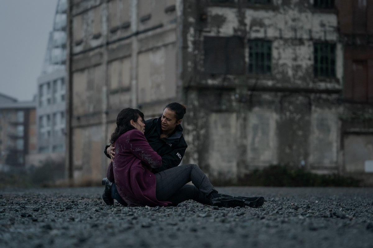 Angel Coulby kneels down next to Georgina Campbell in a scene from 'Suspicion' Season 1 Episode 4: 'The Devil You Know'